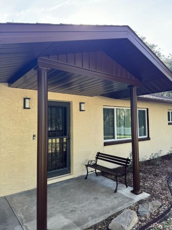 Freshly painted Brandon, FL house exterior with covered front porch, bench, and windows